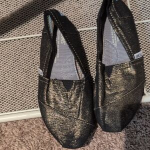TOMS Glittery Black and Gold Slip-Ons